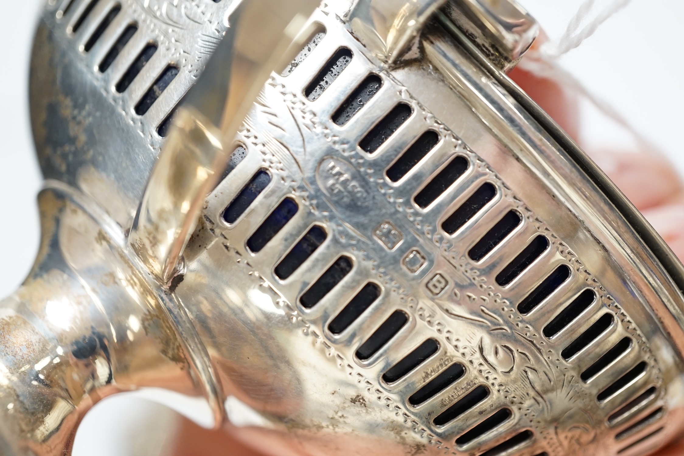 A 1930's George III style five piece silver cruet set, London, 1936/37, with three associated spoons, one silver plated.